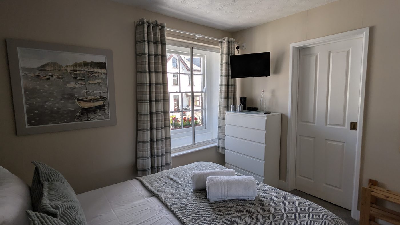 Window wall with a large boat painting in one of the double rooms