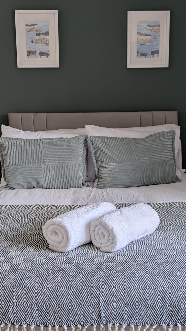 Rolled towels and corduroy cushions in one of the refurbished double rooms
